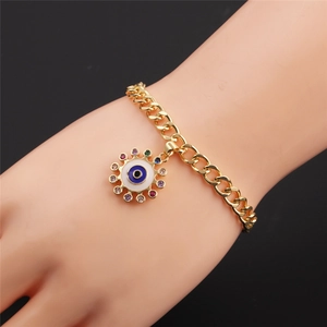 Detailed view of evil eye bracelet with colorful zircons on golden Cuban chain links