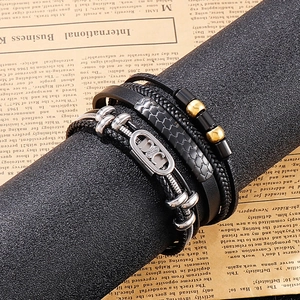Close-up of men's multi-layer braided leather bracelet with magnetic metal clasp