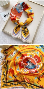 Detail of satin scarf featuring traditional Chinese deer and cloud illustrations