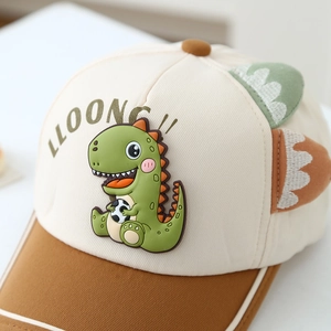 Child baseball cap with cartoon dinosaur patch and decorative fins in beige and brown