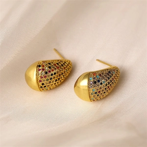 Close-up of golden teardrop earrings featuring colorful pave-set cubic zirconia crystals