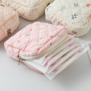 Quilted fabric pouch for feminine products with cute bunny and floral patterns