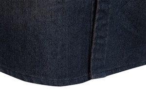 Macro shot of dark blue denim fabric texture and detailed single stitching on male shirt