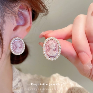 Vintage oval relief portrait earrings with pearl border trim for an elegant retro style