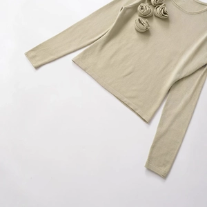 Elegant beige long-sleeve knit sweater featuring three 3D floral decorations on the neckline