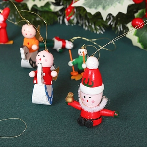Macro shot of hand-painted wooden Christmas ornaments with gold strings on festive green