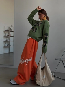 Lazy style crew neck mushroom pattern green knit sweater with loose orange wide leg trousers
