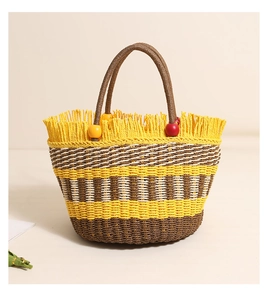 Detail of hand-woven straw bucket bag with colorful wood beads and fringe tassels