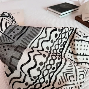 Macro shot of black and white geometric tribal pattern on thick linen tote bag fabric