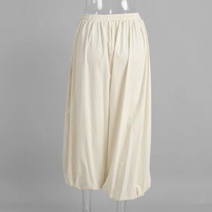 Detailed macro view of elastic waistband and creamy cotton fabric on harem pants
