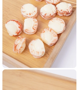 Macro detail of artificial PVC scallop meat with realistic texture on a bamboo tray