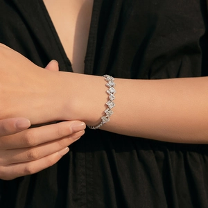 Macro view of bohemian style 18K silver plated bracelet with mixed geometric zircons