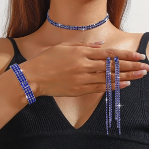 Detail of silver choker necklace and long fringe earrings with navy blue rhinestones
