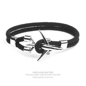 Minimalist black polyester cord bracelet featuring a silver aircraft-shaped metal clasp
