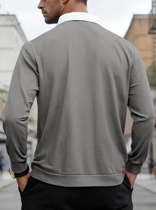 Detail of grey waffle knit texture and white collar stitching on men long sleeve polo shirt
