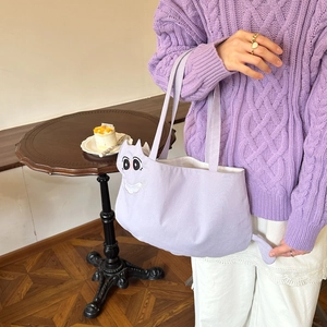 Detail of cute lilac canvas tote bag with 3D cat head silhouette and tail design
