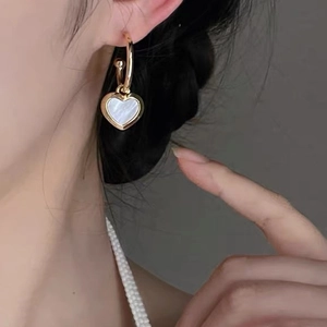French retro gold heart hoop earrings with iridescent mother of pearl on female model