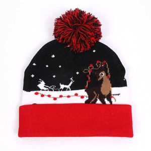 Festive LED Christmas beanie featuring reindeer and snowflake patterns with a pom-pom