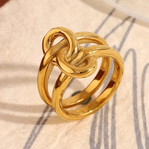 Macro detail of 18K gold plated stainless steel double layered knot ring design