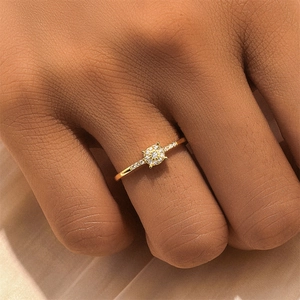 Close-up of gold S925 sterling silver teardrop ring with pavé diamonds on finger