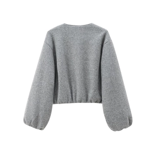 Detailed macro view showing the premium light grey wool texture and elasticated hem of the jacket