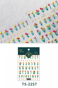 Detail view of 5D gradient tulip nail stickers and gold stars on clear PET film