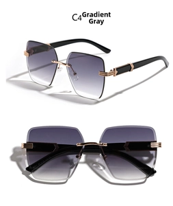 Detail view of rimless square sunglasses with gradient grey lenses and golden hinges