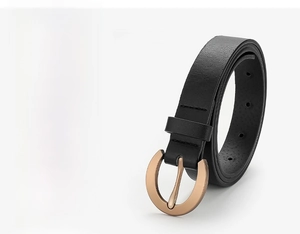 Detail of black textured leather belt with a circular light gold alloy buckle