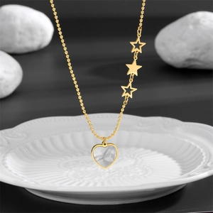 Gold bead chain necklace featuring three stars and a heart pendant with white shell inlay