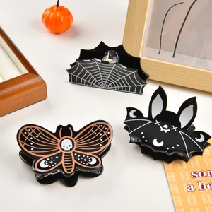 Three-piece Halloween hair claw set featuring spider web, skull moth, and bat designs