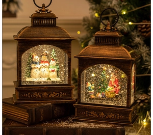 Macro detail of two bronze Christmas lanterns with LED snow scene and glitter effect
