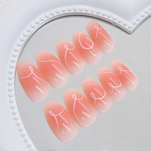 Pink gradient cat eye press-on nails with white heart lines and coffin shape