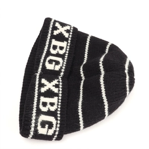 Close-up of black knit beanie featuring white stripes and XBG jacquard lettering detail