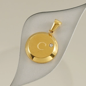 Macro view of 18K gold plated letter C pendant with sparkling diamond accent detail