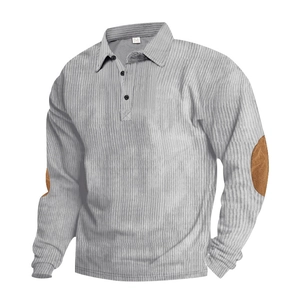 Close-up of light grey corduroy polo shirt featuring brown elbow patches and textured fabric
