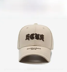 Detailed close-up of brown 3D embroidery and lettering on a beige baseball cap