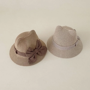 Straw baby sun hat with cute cat ears and bow tie in brown and beige colors