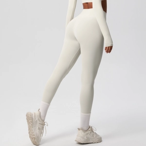 Close-up of cream high-waisted yoga leggings and long sleeve crop top fitness set