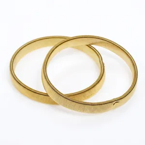 Pair of gold elastic metal spring armbands with a polished finish for men