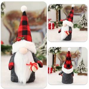 Detail view of a Christmas gnome with red buffalo plaid hat and holly berry accents