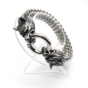 Detailed view of silver stainless steel viking bracelet with dual wolf head design