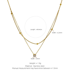 Detail of 18K gold-plated double-layer necklace with golden beads and zircon pendant