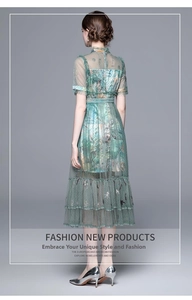 Rear view of green tiered mesh maxi dress featuring vintage floral prints and standing collar