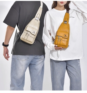 Detail of waterproof leather chest bag with metal buckles and brand logo engraving