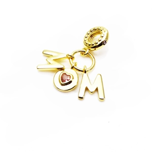 Detailed close-up of a gold MOM letter pendant with a pink heart zircon and beaded bail