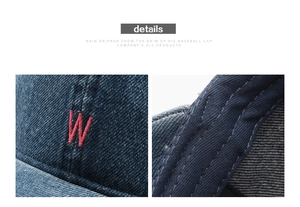 Macro shot of 3D red letter W embroidery and reinforced stitching on denim baseball cap