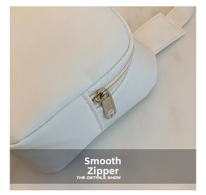 Detail showing smooth white zipper and fine canvas fabric texture on kids' crossbody bag