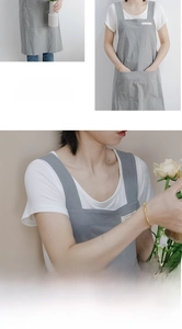 Macro detail of grey cotton linen apron with widened shoulder straps and dual pockets