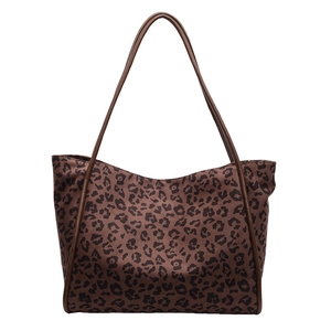 Minimalist leopard print tote bag for women featuring canvas fabric and leather straps