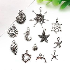 Macro view of antique silver ocean theme alloy charms including starfish and seashells